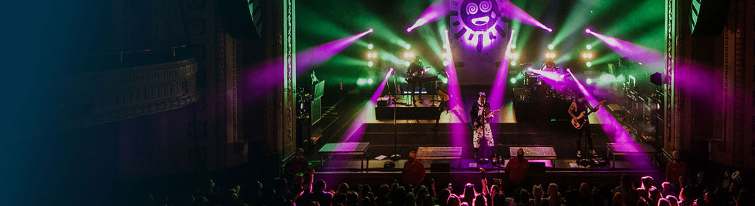 The Venue banner featuring a colorful live concert scene with vibrant stage lights and a performing band.